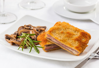 A cachopo consists of two large veal fillets and includes ham and cheese. Typical from the Asturias region in Spain.
