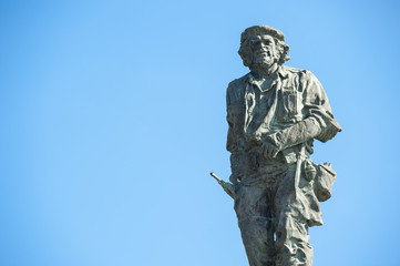Statue of Cuban revolutionary Che Guevara stands in blue sky at a mausoleum dedicated to him and...
