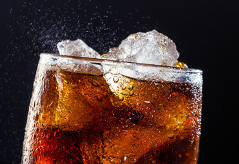Cola drink fizz with ice in a glass - obrazy, fototapety, plakaty