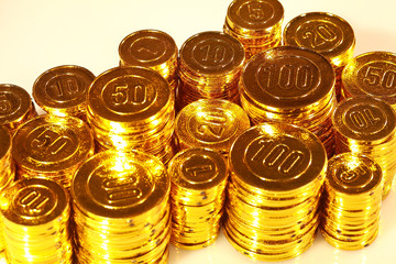 Golden coins piled in a heap of background