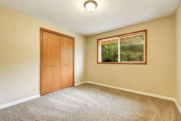 Empty room with built in wardrobe and carpet floor