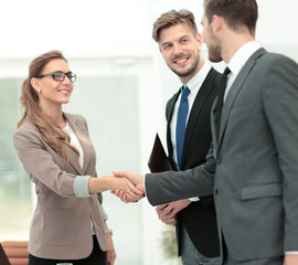 Business partners shaking hands in the modern office