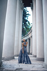 young lady in dress at the entrance of neoclassical building
