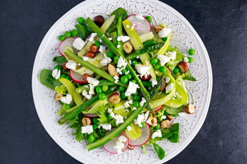 Fresh Green Asparagus salad witch Goat Cheese, peas, radishe, zucchini, lettuce and Hazelnuts.