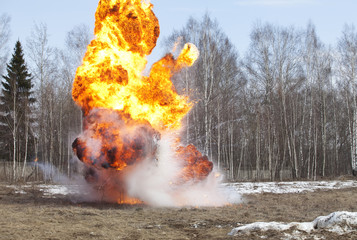 Explosion in action with fire ball and smoke
