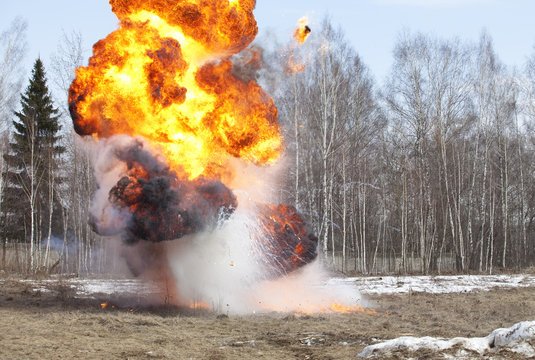 Explosion in action with fire ball and smoke
