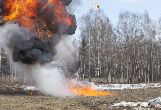 Explosion in action with fire ball and smoke
