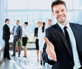 Portrait of a successful businessman giving a hand