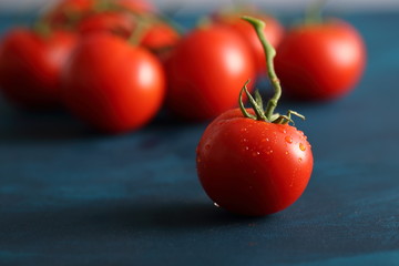 tomato with drops on a blue background