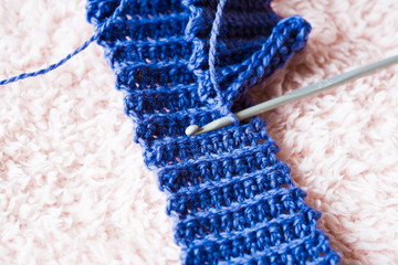 Knitting. Blue elastic band, close up