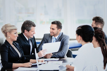 Fototapeta premium Image of business partners discussing documents and ideas at meeting