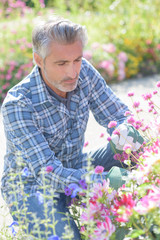 man and flowers in the garden