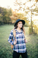 Outdoor adventurer posing with hat and backpack