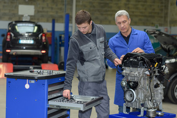 mechanic apprentice in a garage learning the job