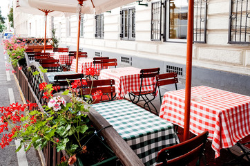Street view of a coffee terrace with tables and chairs in europe