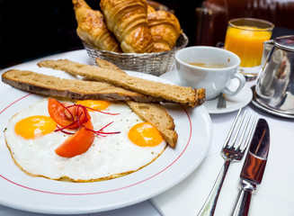 Breakfast with coffee and croissants on table
