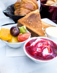 Breakfast with fresh fruits and croissants on table