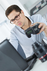 man in casual wear sitting at his working