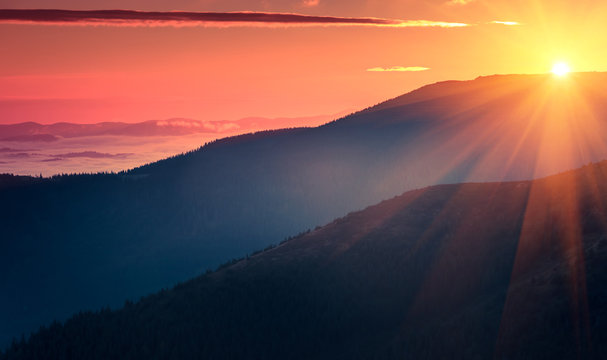 Panoramic view of  colorful sunrise in mountains. Filtered image:cross processed vintage effect.