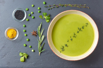 food background of Pureed pea soup with spices, fresh mint and garlic (vegan, vegetarian)