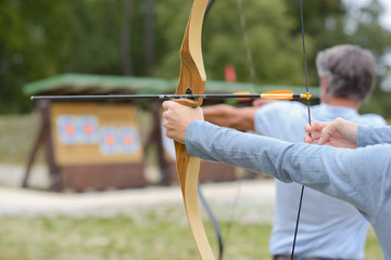 Man and woman practicing archery