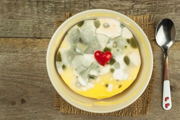 Moldy pudding. Poisonous food full of mold. Unhealthy food. Spores of the fungus for food. Growing mold.
