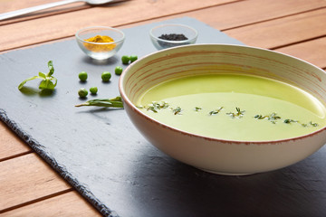 food background of Pureed pea soup with spices, fresh mint and garlic (vegan, vegetarian)