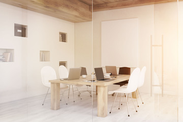 Side view of conference room with glass walls and doors, toned