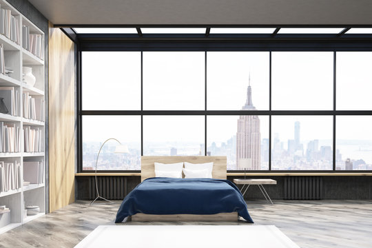 View of New York bedroom with poster and bookcase