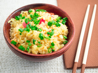 Brown bowl with a portion of cooked rice