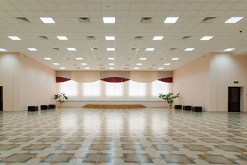 large room with a window and a stage