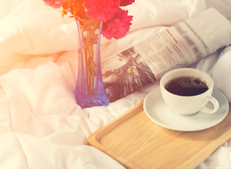 Cup of coffee,newspaper and pink rose flower with wooden tray se