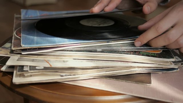 Vintage records, browsing the records in LP collection. The stack of vinyl records.