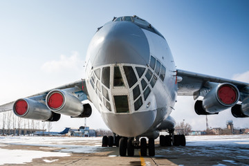 Close-up front view of widebody cargo aircraft in a cold winter airport