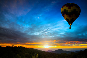 Colorful hot-air balloons flying over the mountain