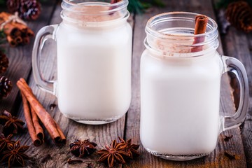 Christmas drink: eggnog with cinnamon stick in mason jars