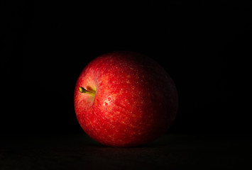 Fototapeta na wymiar Big red apple in drops of wate