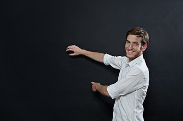 Young Adult Male in White Shirt Gesturing, Showing, Teaching