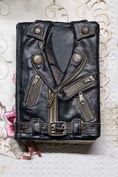 vintage leather jacket style bible cover on the table. Mini biker bible jacket.