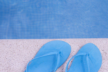 Blue flip flops on pool