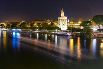 Fototapeta na wymiar Dodecagonal military watchtower Golden Tower or Torre del Oro at night, Seville, Andalusia, Spain