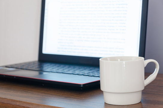 Coffee cup and Laptop computer