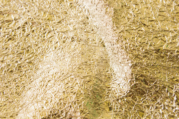 Gold wrinkled paper texture abstract background