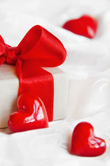 Gift box with red bow and hearts