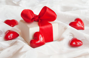 Gift box with red bow and hearts