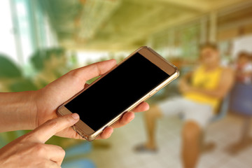 woman hand holding and touch screen of smartphone,tablet,cell phone over passenger lobby  on ferry