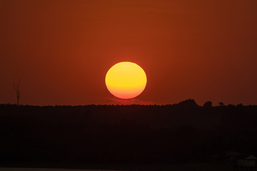 Beautiful sunset over silhouette mountain skyline with orange sky background. full sunset
