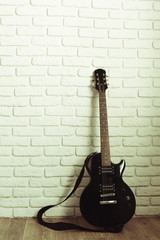 Obraz na płótnie Canvas Electric guitar body and neck detail on wooden background