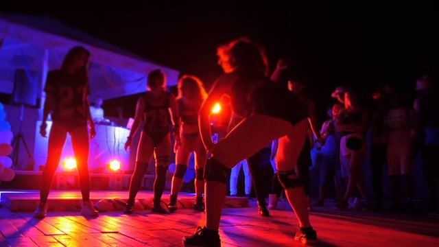Twitching legs and booty dancing girl close up on stage in club