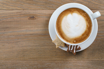 cup of cappuccino with homemade christmas cookies